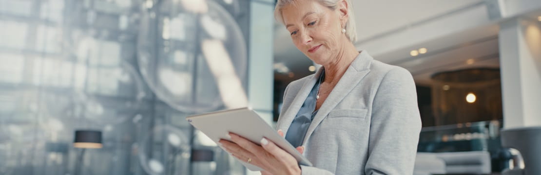 Businesswomen reviewing a tablet in an office.